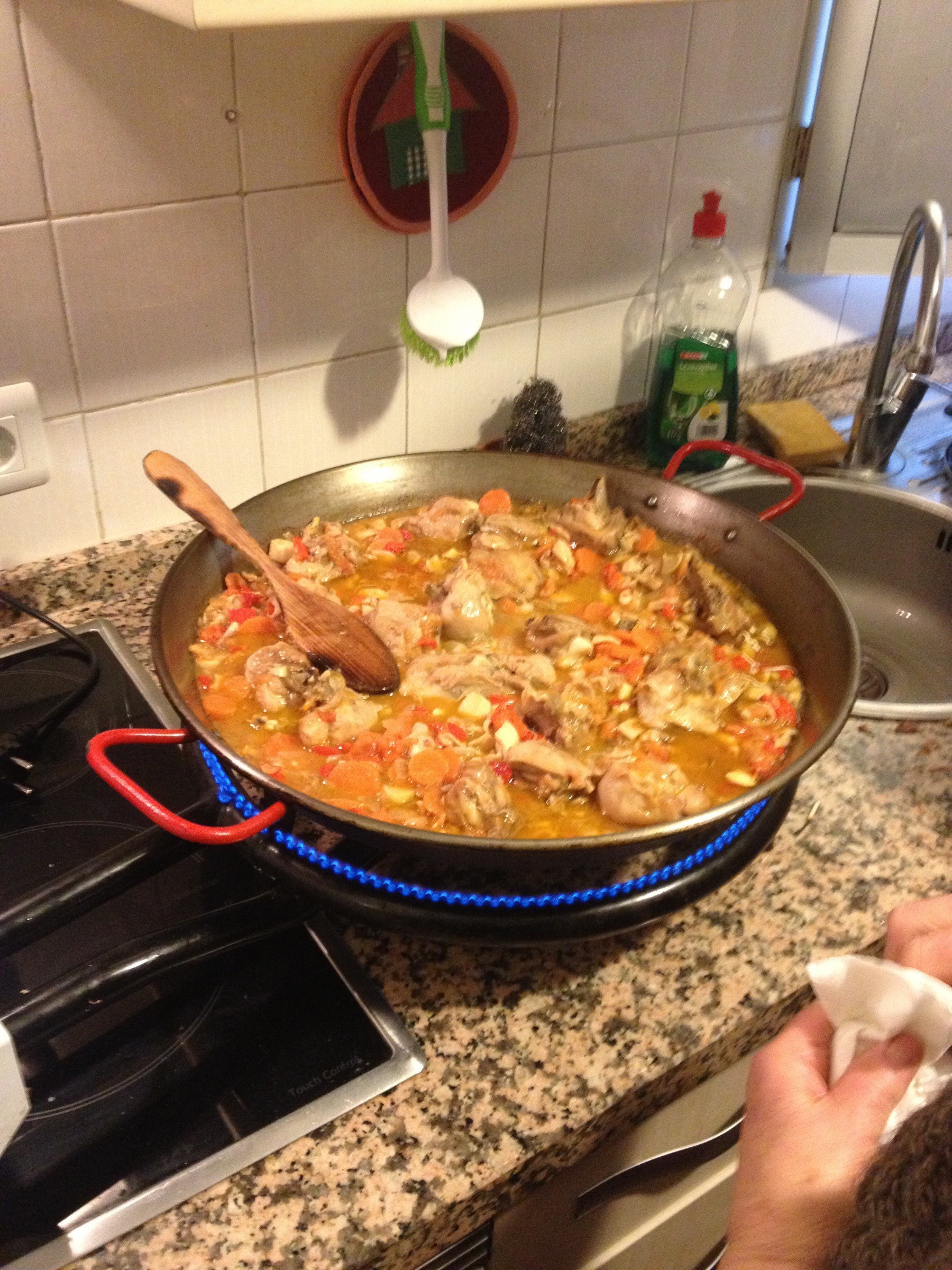 Pan with homemade paella on kitchen counter.